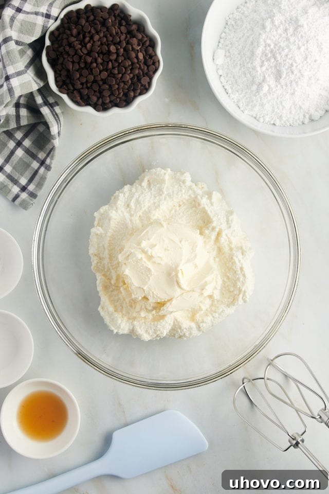 overhead view of ricotta and mascarpone cheeses in a glass mixing bowl