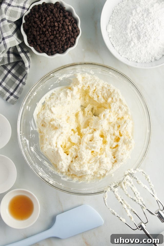 overhead view of mixed ricotta and mascarpone cheeses in a glass mixing bowl