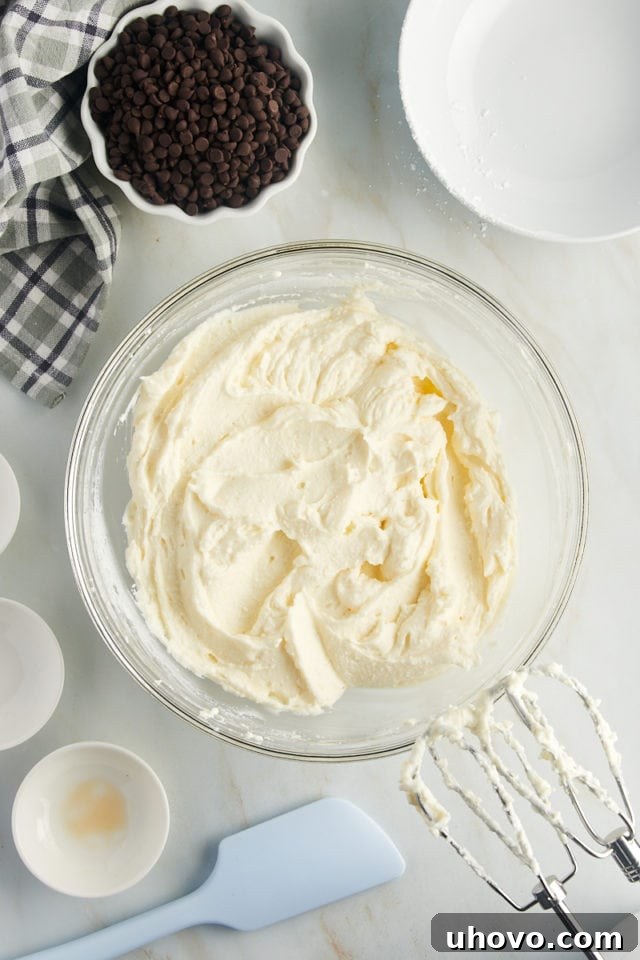 overhead view of mixed cannoli dip in a glass mixing bowl