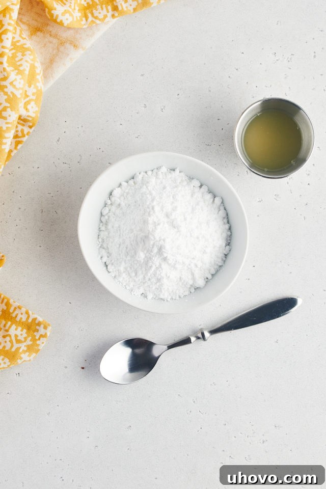Overhead view of lemon juice and powdered sugar in bowls