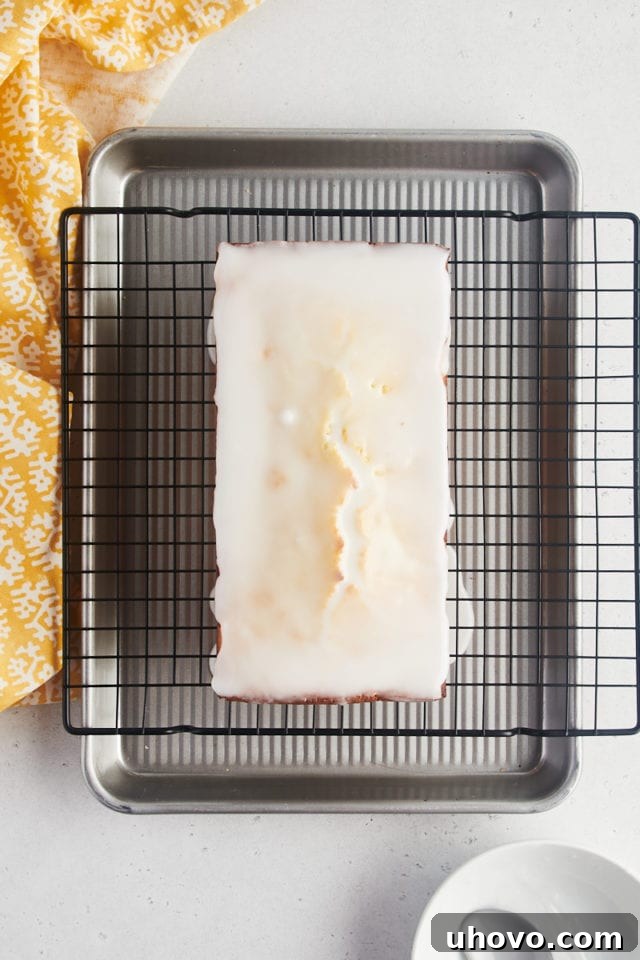 Overhead view of lemon loaf cake after adding glaze