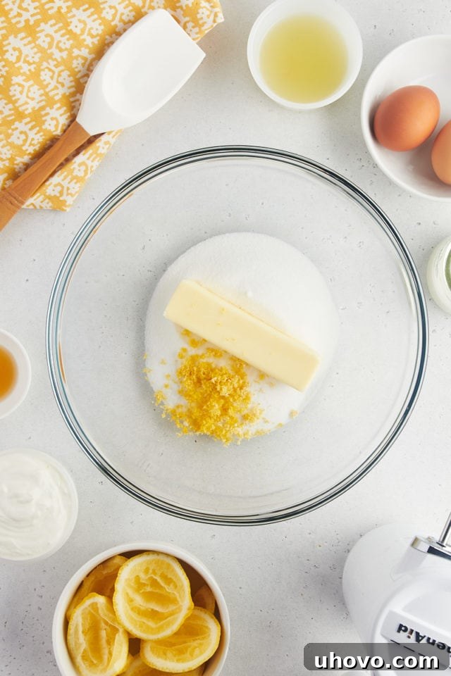 Overhead view of lemon zest, butter, and sugar in mixing bowl