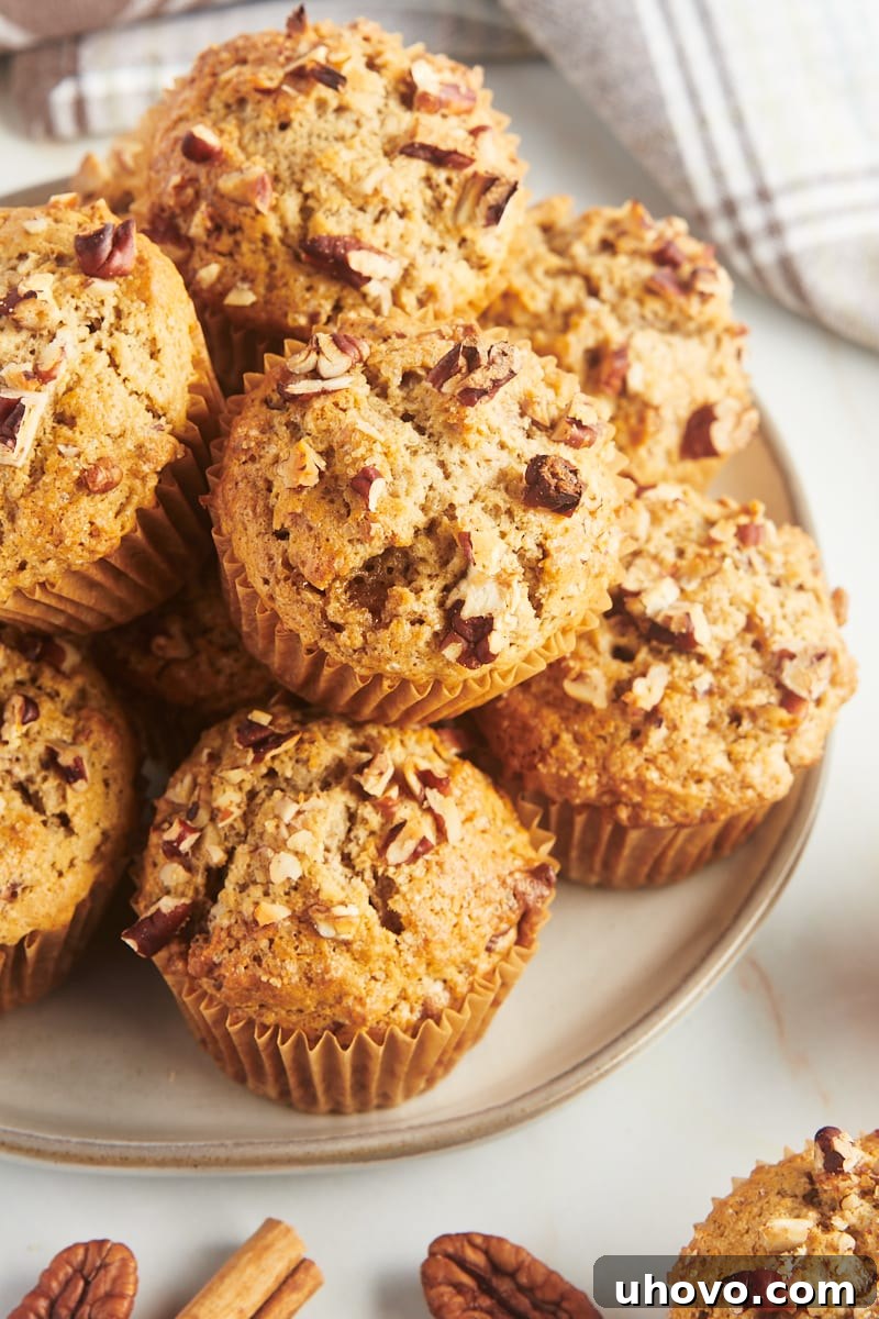 Cinnamon pecan muffins stacked on platter