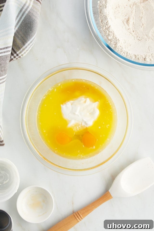 Overhead view of liquid ingredients for muffins in bowl before mixing