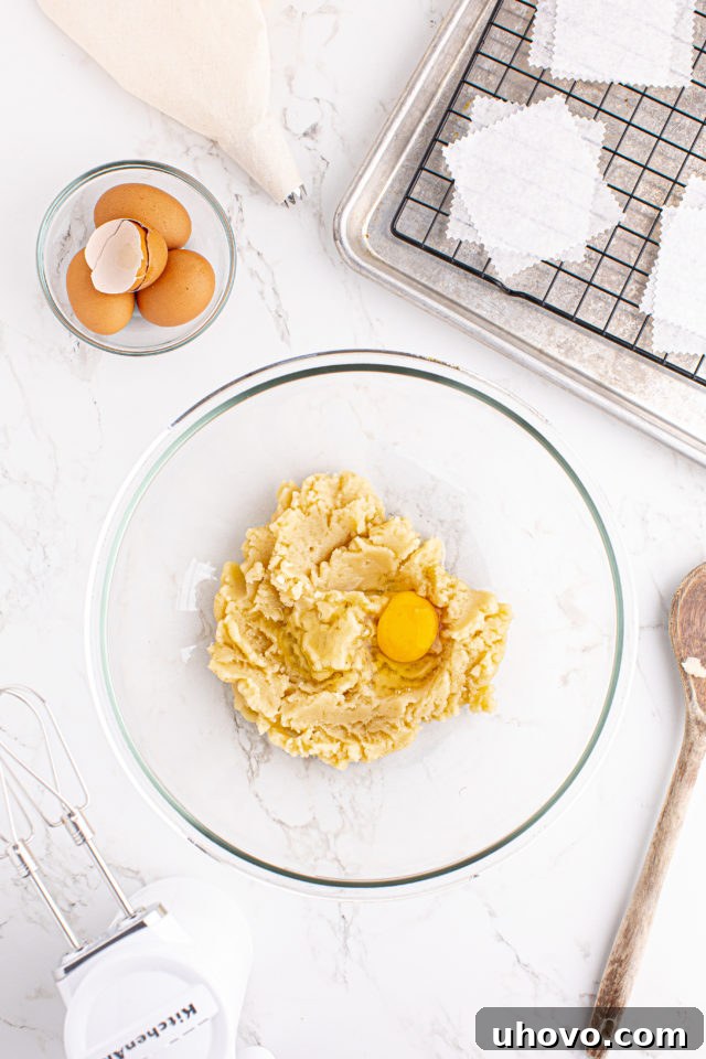 Overhead view of egg added to choux pastry