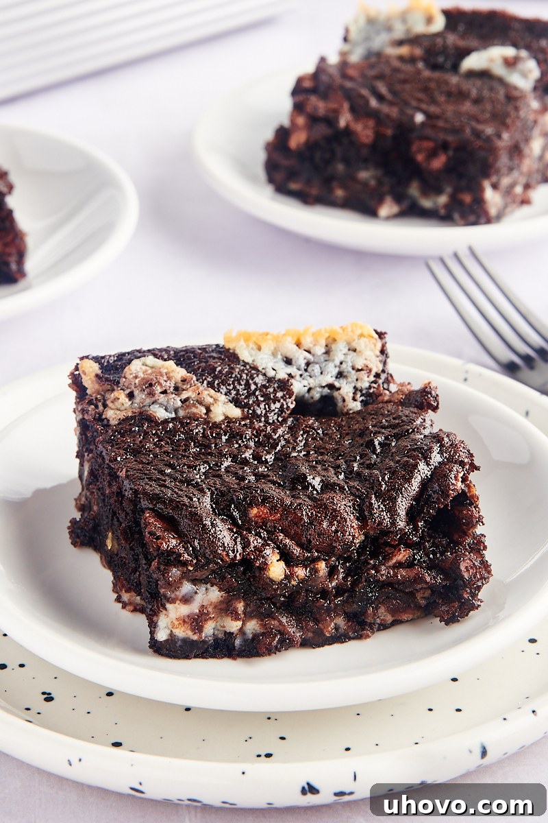 Slices of earthquake cake on plates, showing swirls of cream cheese and fudgy texture