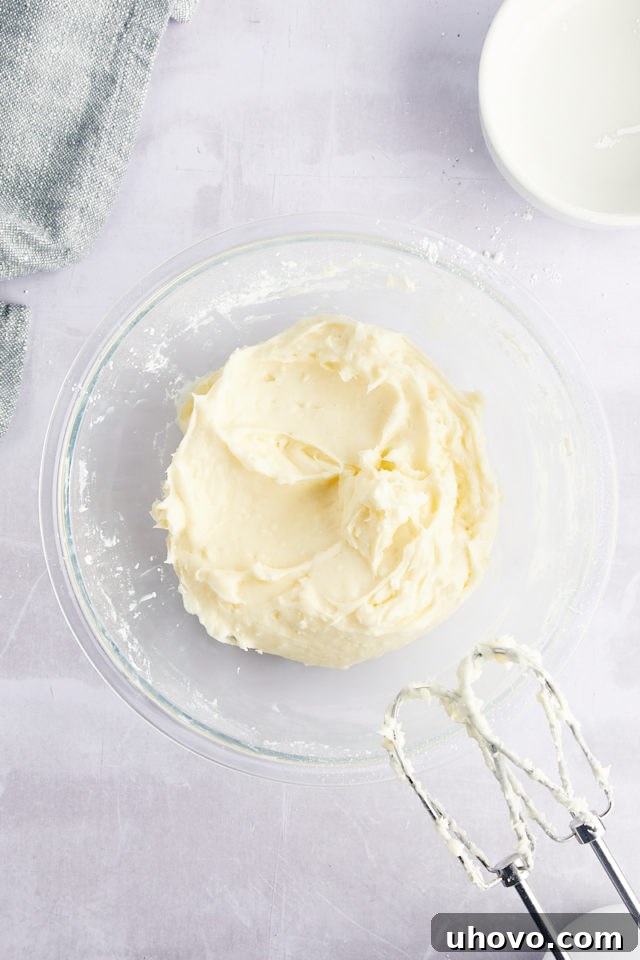 Overhead view of cream cheese mixture in mixing bowl