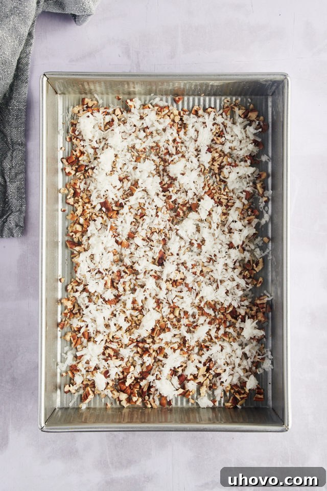 Overhead view of coconut and pecans in pan