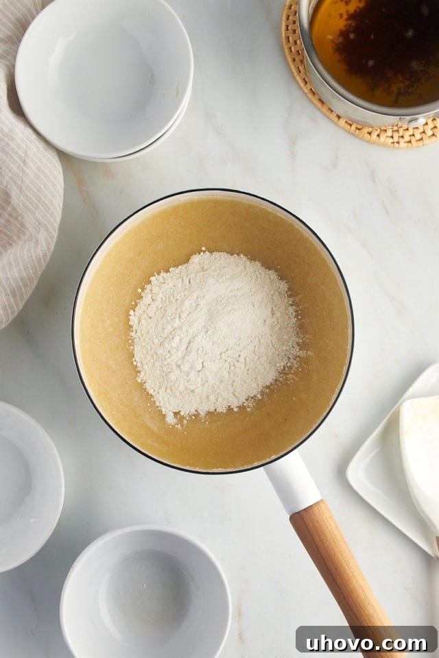 overhead view of flour added to egg white mixture for financiers