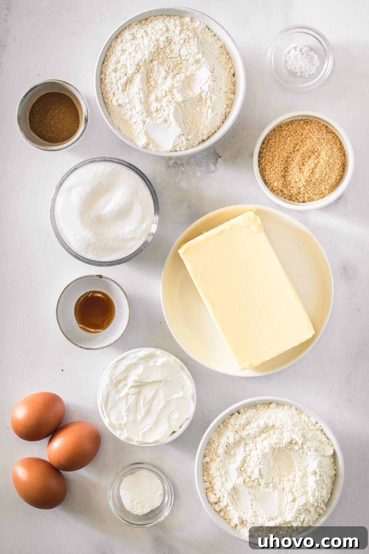 An overhead view showcasing all the simple yet high-quality ingredients laid out for making the classic crumb cake.
