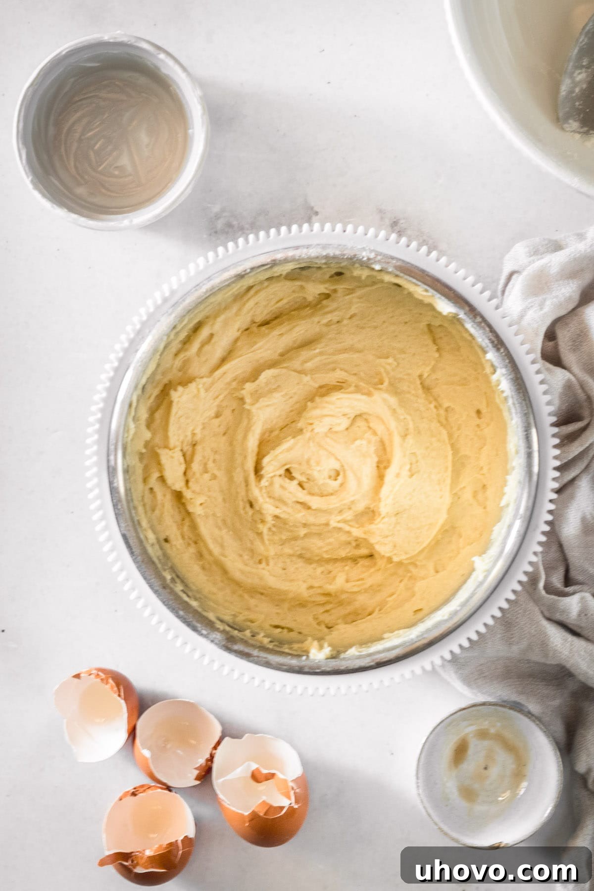 Overhead view of the smooth, creamy cake batter in a mixing bowl after all wet and dry ingredients have been combined.