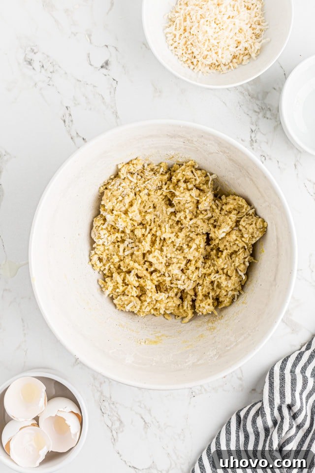 Overhead view of the fully combined gooey coconut mixture in a mixing bowl
