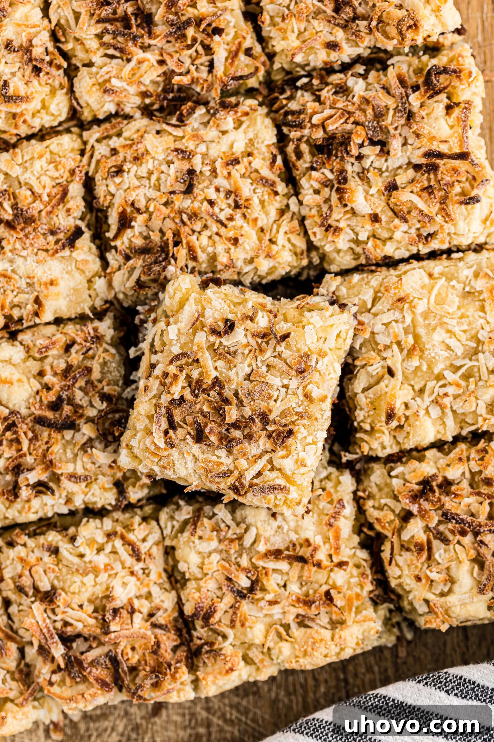Overhead view of perfectly cut Black-Bottom Coconut Bars arranged on a serving plate