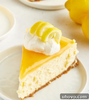 A slice of lemon cheesecake on a white plate