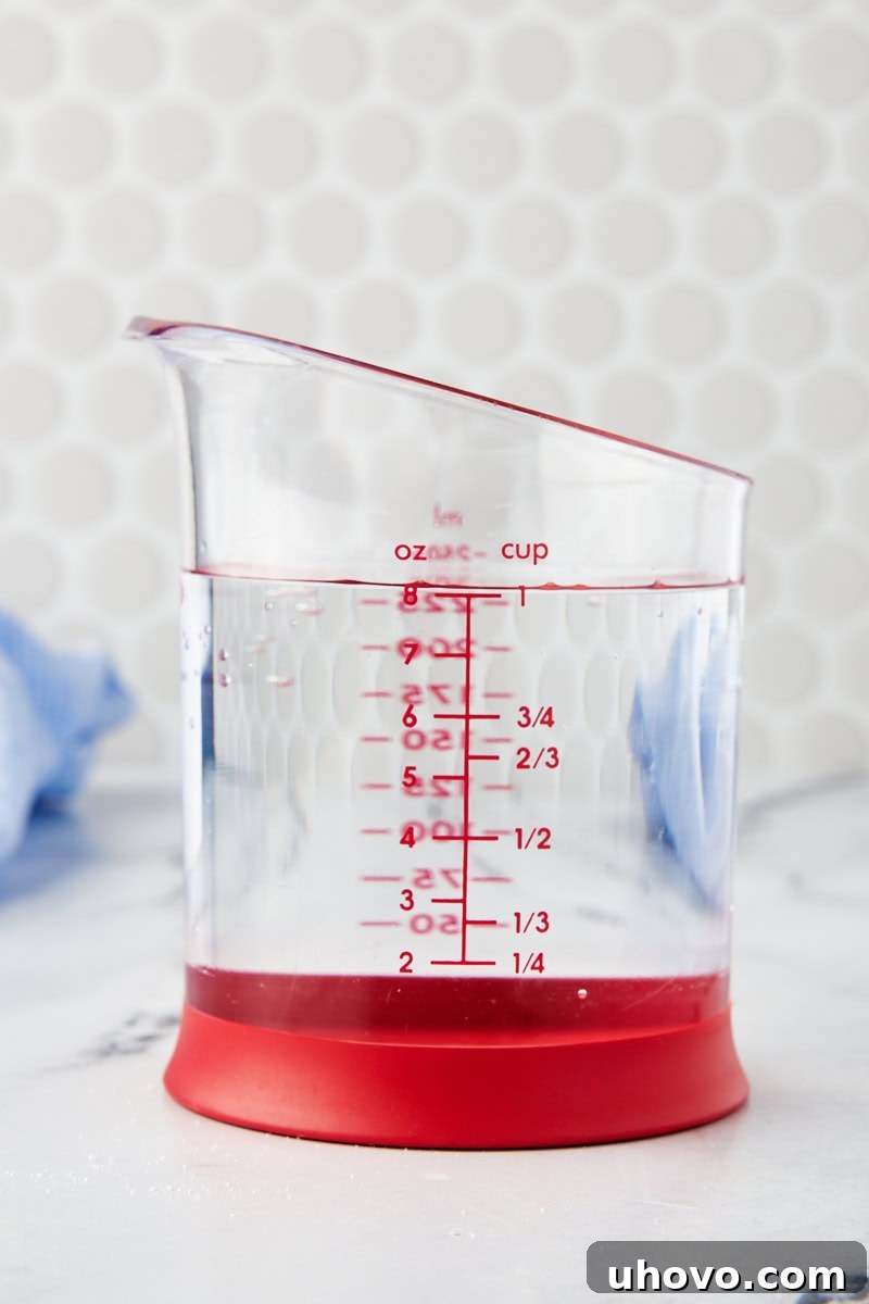 water accurately measured in a clear liquid measuring cup on a level surface