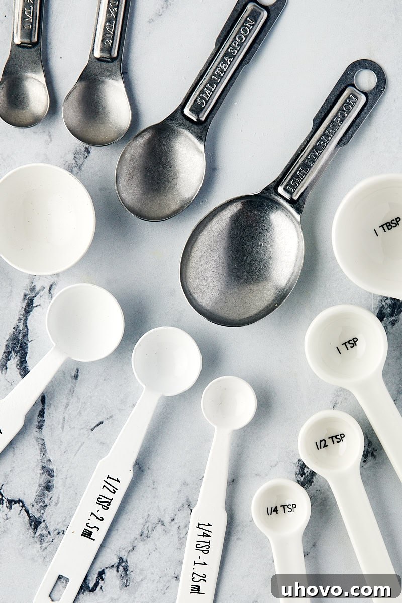 overhead view of various measuring spoons in different sizes, essential for small quantity measurements