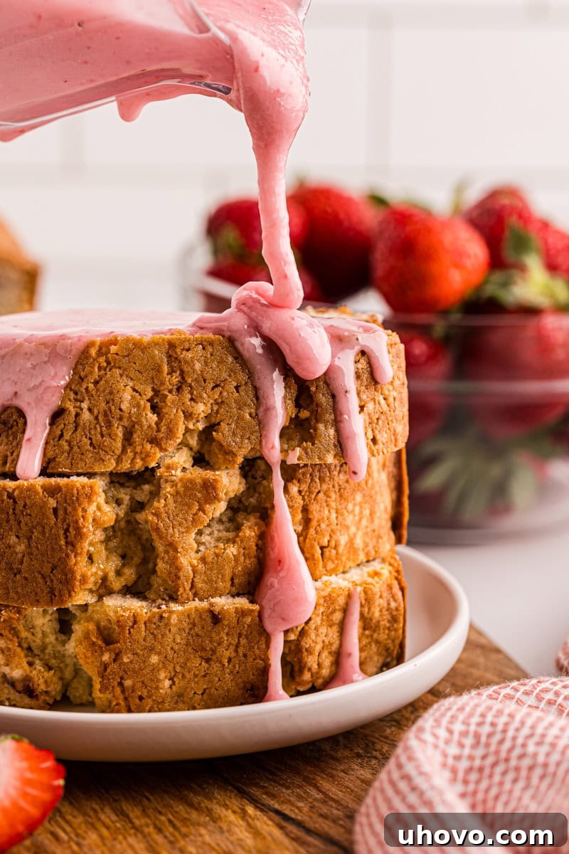 Rich strawberry glaze cascading over a stack of three perfectly sliced strawberry pound cake portions, arranged on a white plate, inviting indulgence.