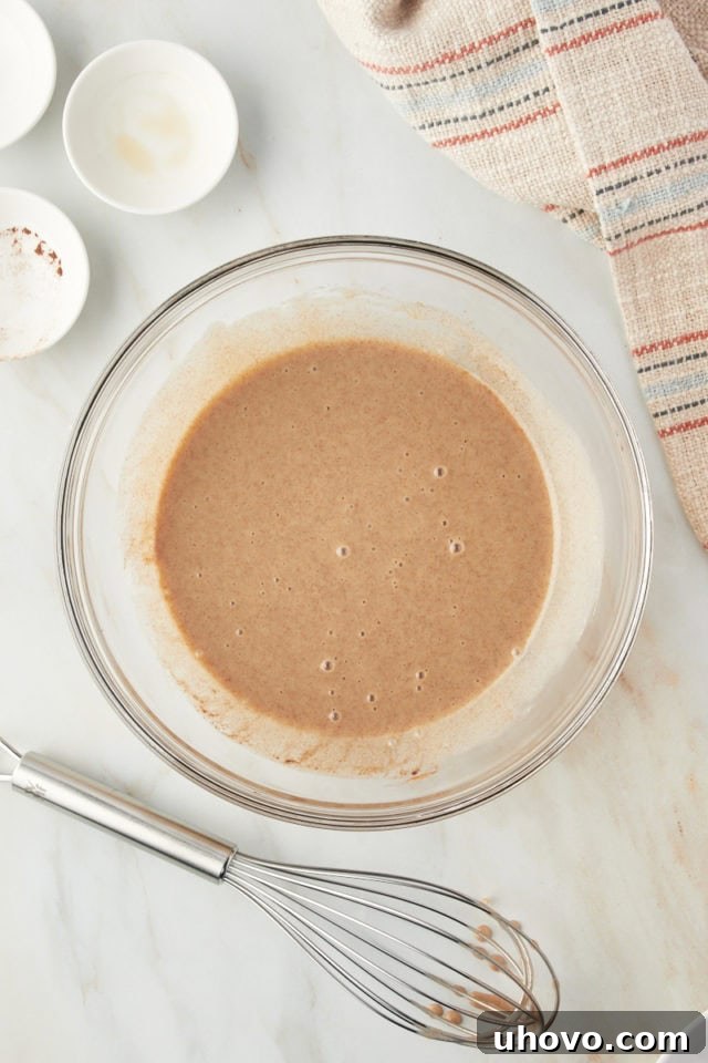 Overhead view of a bowl containing the cinnamon-infused condensed milk mixture