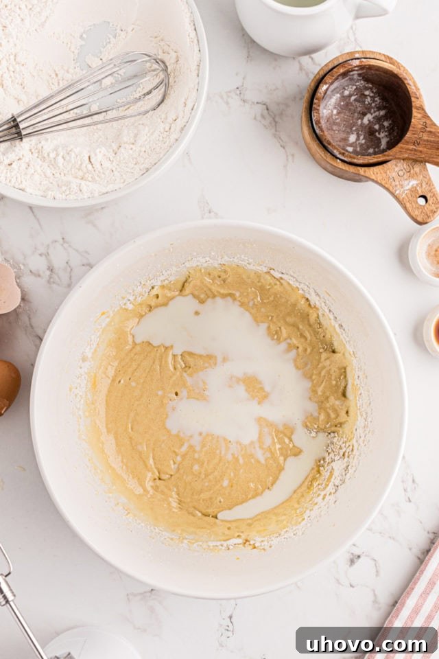 overhead view of milk added to strawberry coffee cake batter