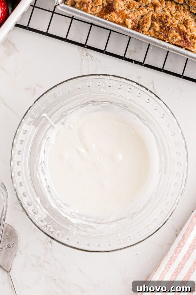 overhead view of mixed glaze for strawberry coffee cake