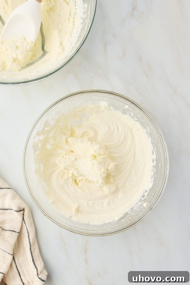 overhead view of whipped cream added to cream cheese mixture for s'mores pie