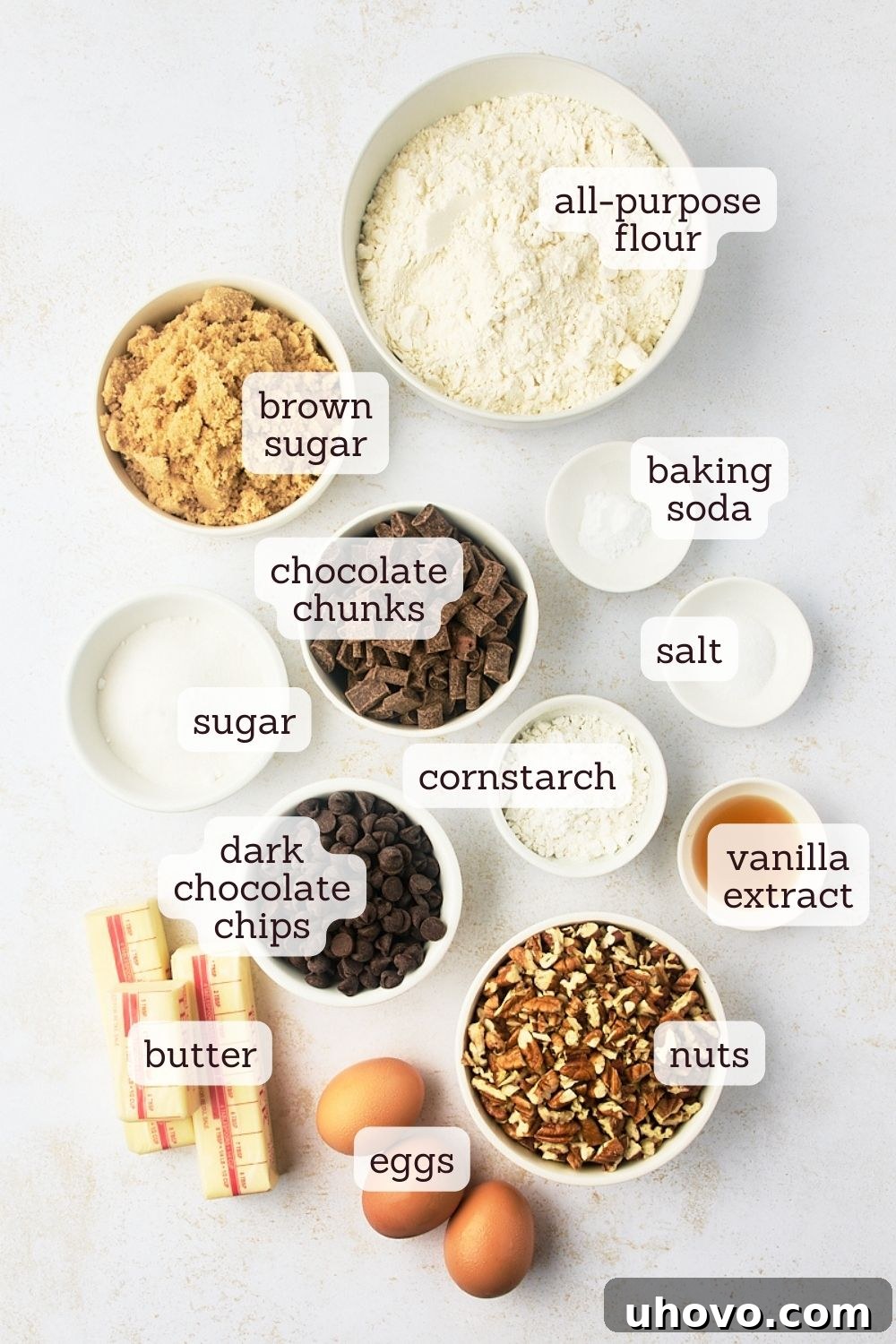 Overhead view of all the measured ingredients for thick chocolate chip cookies, neatly arranged and labeled.