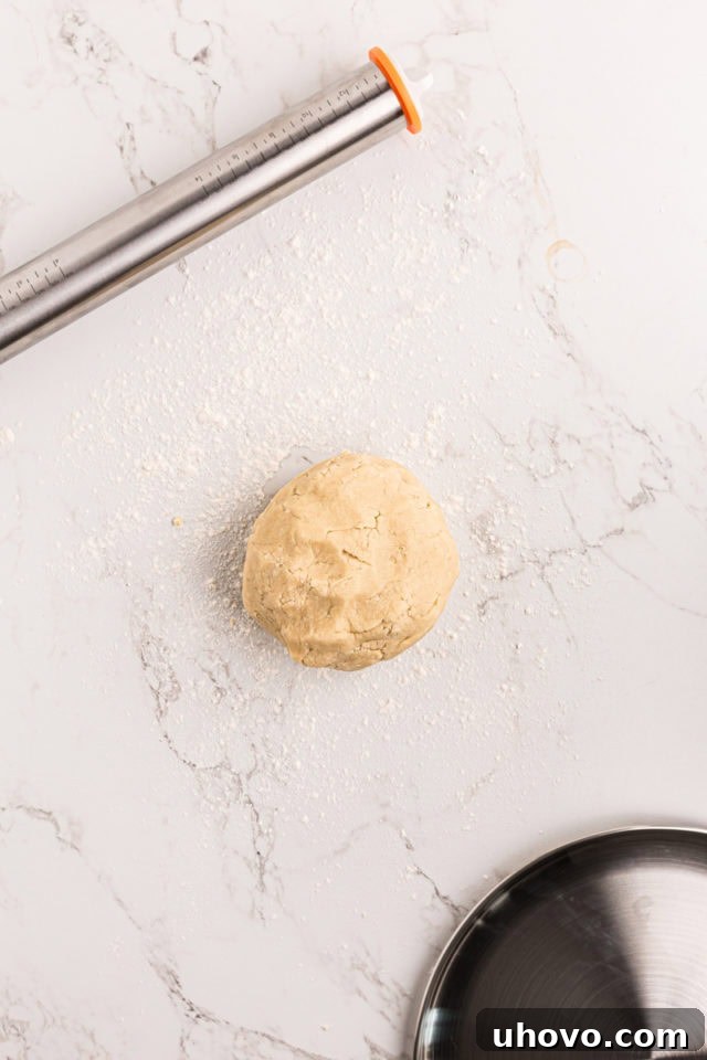 overhead view of sugar cookie crust dough on a floured surface