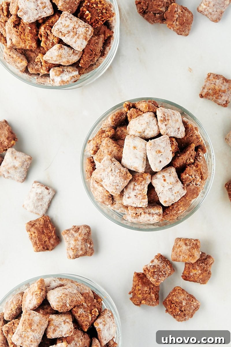 overhead view of muddy buddies in small glasses with more muddy buddies scattered around them, perfect for individual servings
