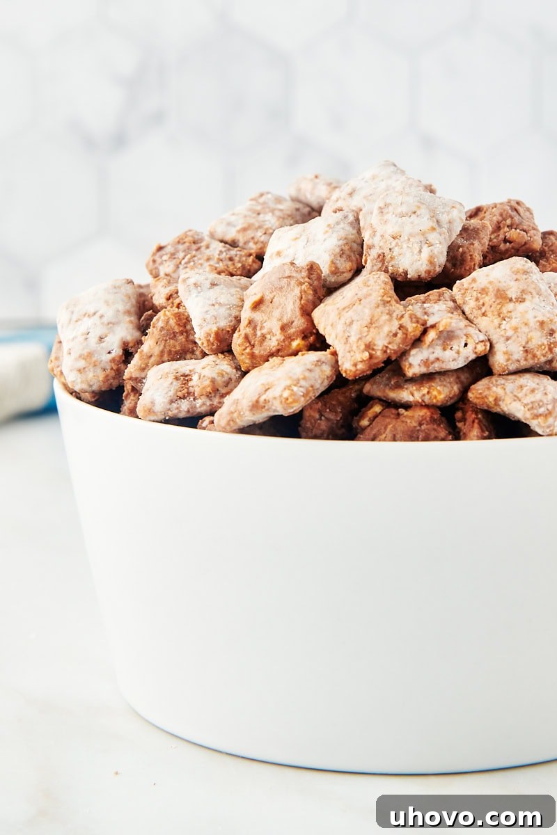 muddy buddies in a white bowl, close-up shot emphasizing the texture and coating