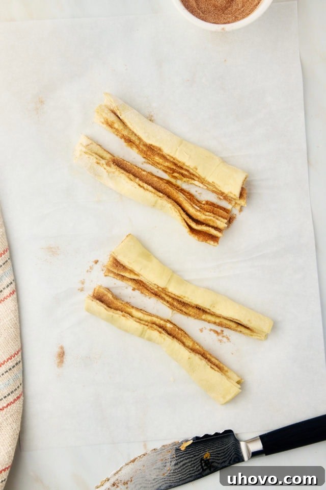 An overhead shot showcasing the cruffin dough after being cut into four distinct portions, prepared for shaping.
