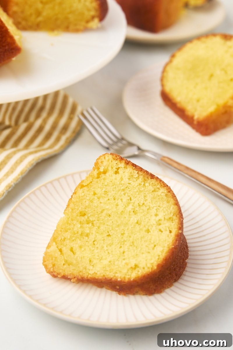 a slice of Kentucky butter cake on a plate with more cake in the background