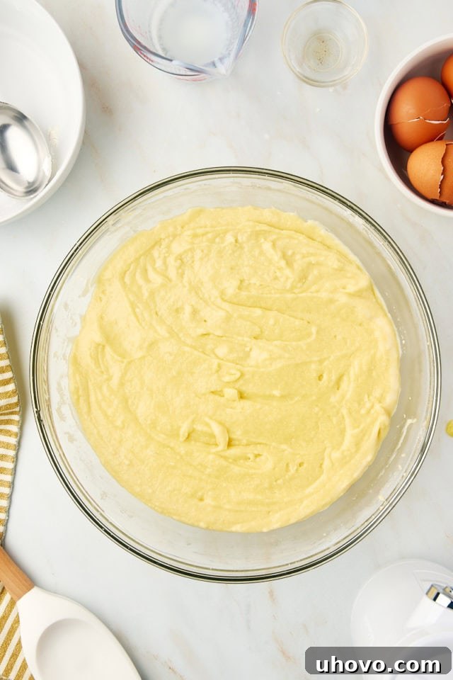 overhead view of mixed Kentucky butter cake batter in a glass mixing bowl