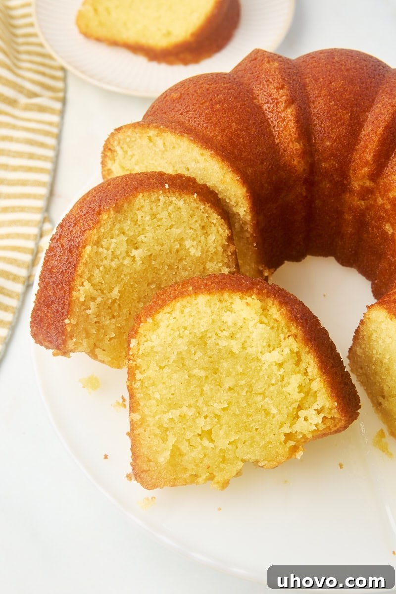 partially sliced Kentucky butter cake on a white cake plate