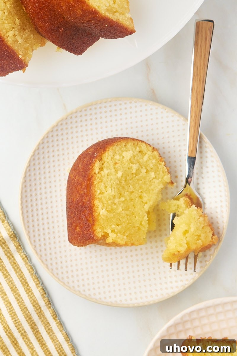 overhead view of a slice of Kentucky butter cake on a plate with a bite on a fork