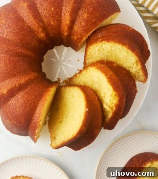 overhead view of partially sliced Kentucky butter cake on a cake stand with two more slices on plates alongside