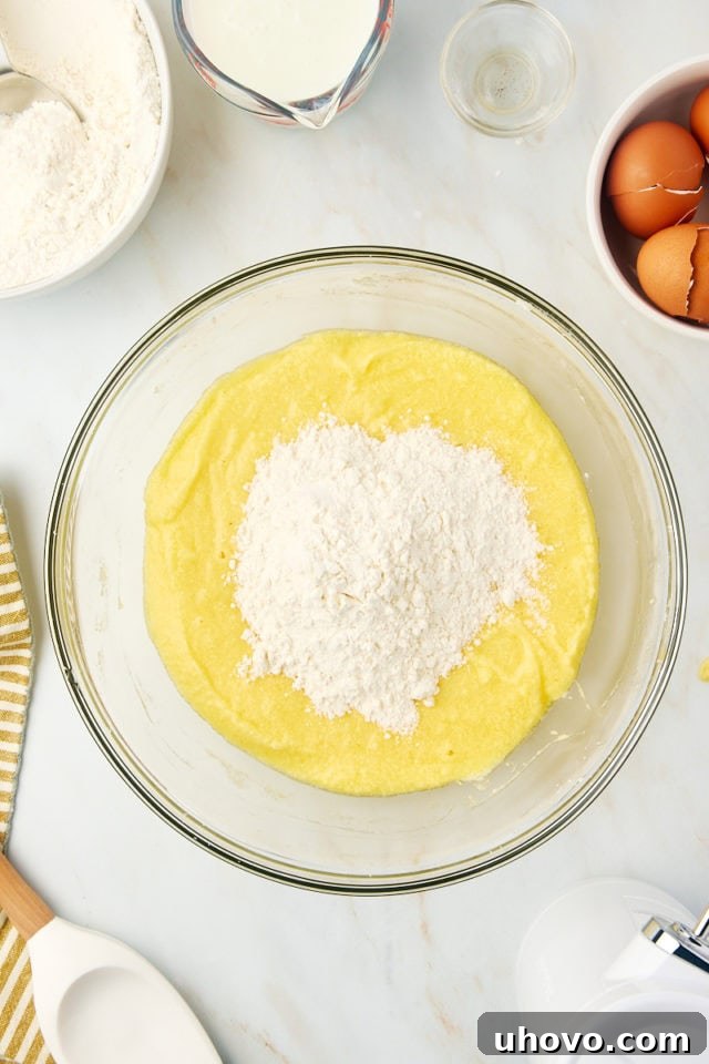 overhead view of dry ingredients added to wet ingredients for Kentucky butter cake