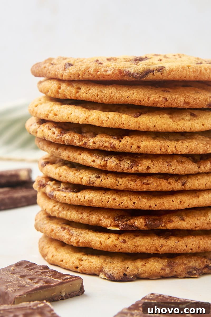 A perfectly stacked pile of Heath bar cookies, showing their texture and inviting appearance.