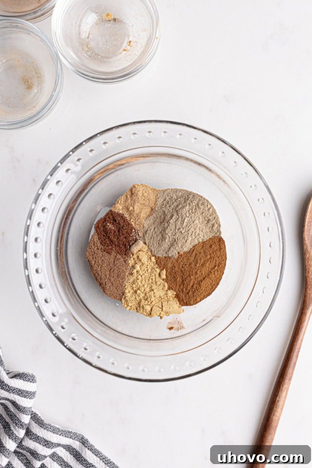 Overhead view of a glass bowl filled with a freshly combined chai spice blend.