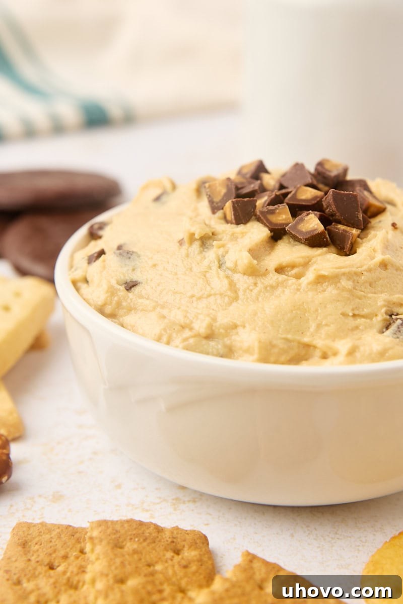Creamy peanut butter cup dip in a elegant white bowl, ready to be enjoyed.