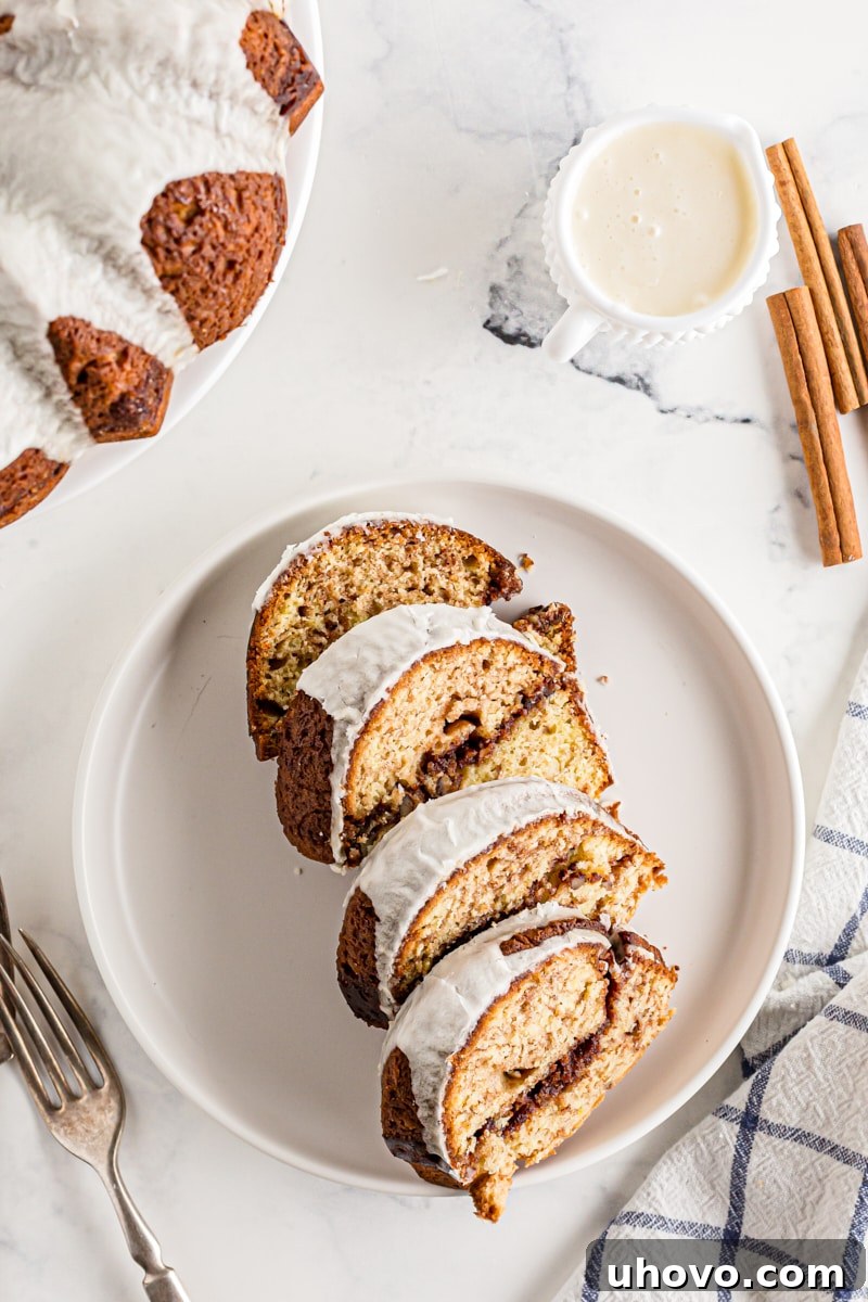 Four perfectly cut slices of Cinnamon Roll Cake arranged neatly on a serving plate, ready to be enjoyed.