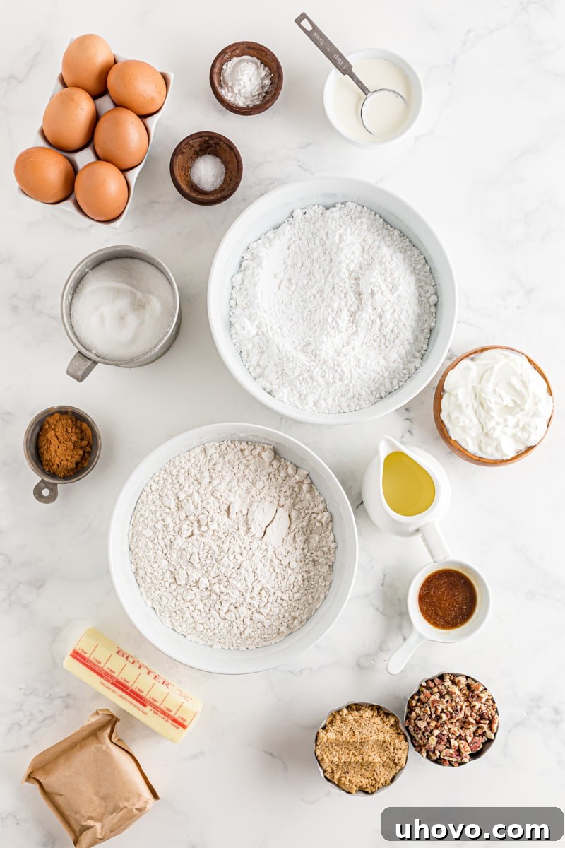 All the fresh ingredients for a delicious homemade Cinnamon Roll Cake meticulously laid out on a kitchen counter, ready for baking.