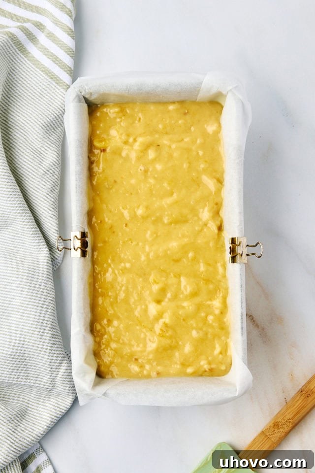 overhead view of banana bread batter in a loaf pan ready to go into the oven
