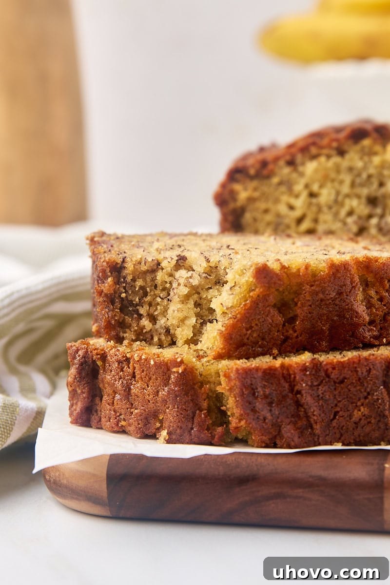 stack of two slices of banana bread with a bite missing from the top slice