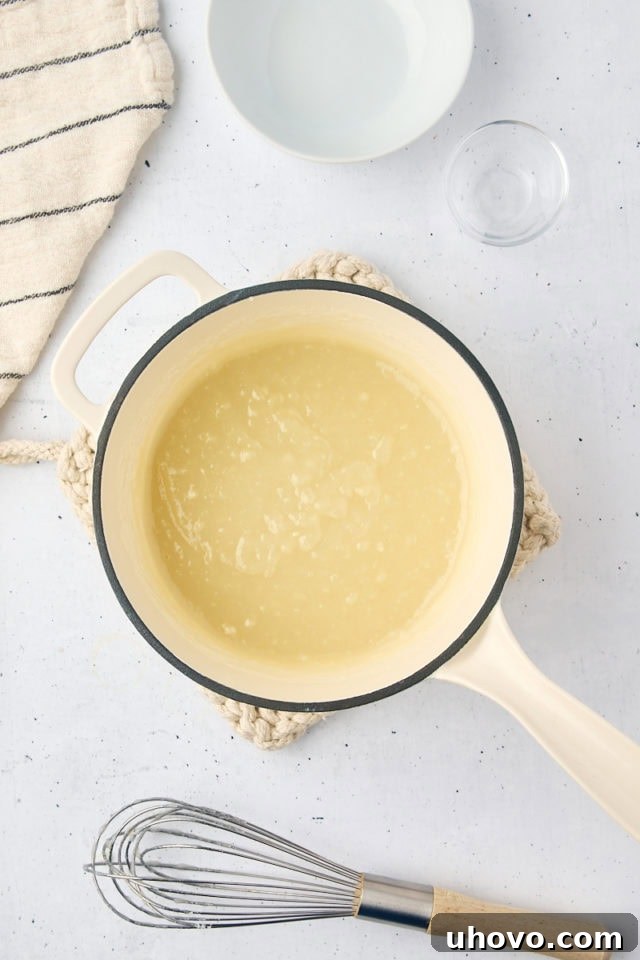 Overhead view of the fully mixed milk mixture for ermine frosting, smooth and thick, cooling in the saucepan.