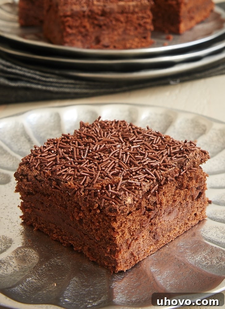 A side view of a brownie with a layer of chocolate cream cheese in the middle.