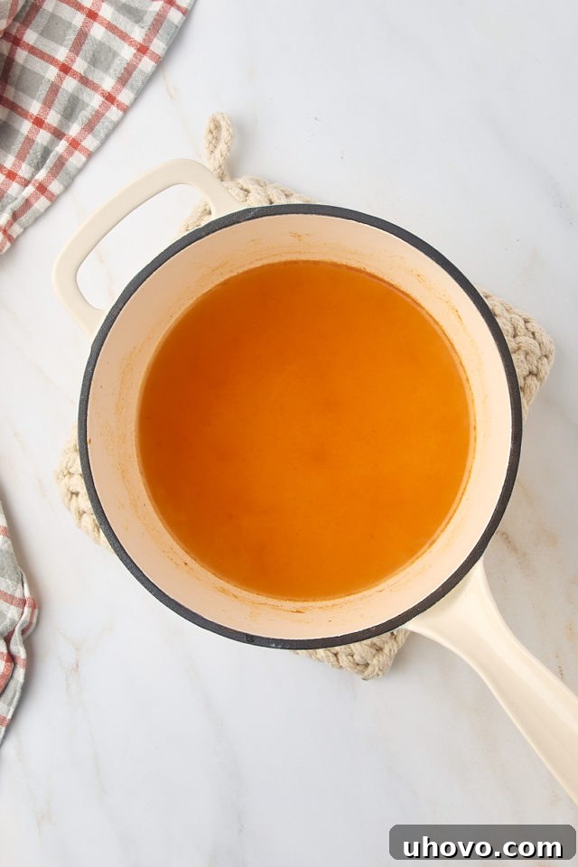 overhead view of reduced apple cider in a saucepan