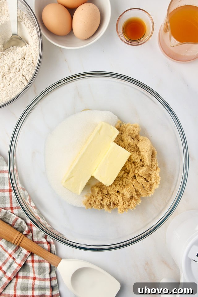 overhead view of butter, sugar, and brown sugar in a glass mixing bowl