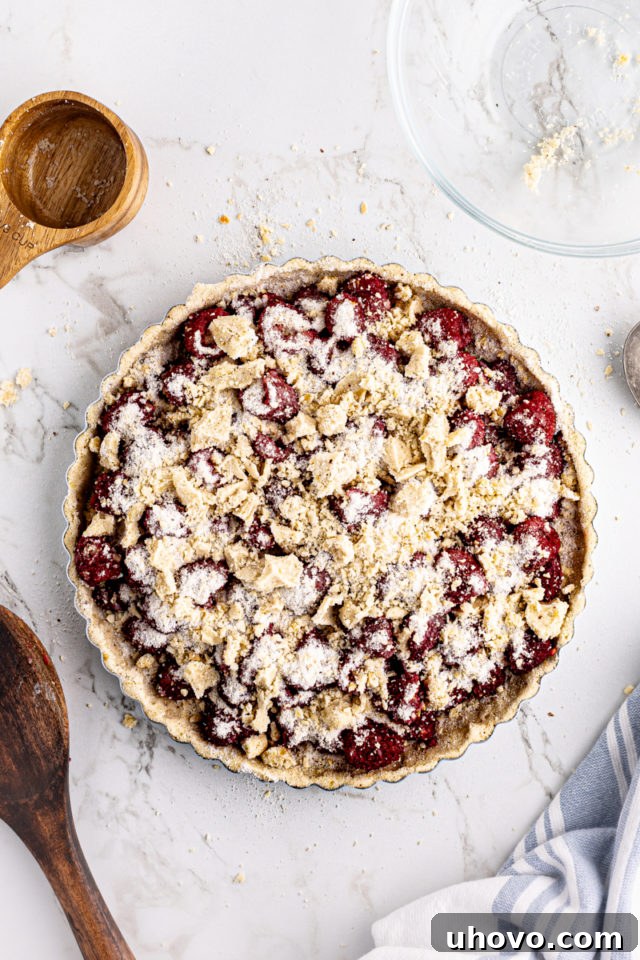 Overhead view of raspberry crumb tart before baking