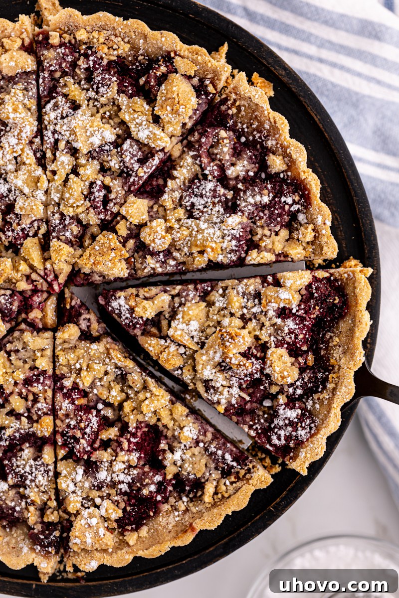 Overhead view of raspberry crumb tart on round platter