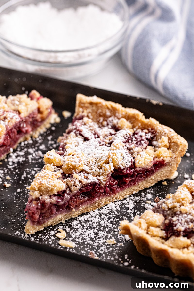 Slices of raspberry crumb tart on rectangular platter
